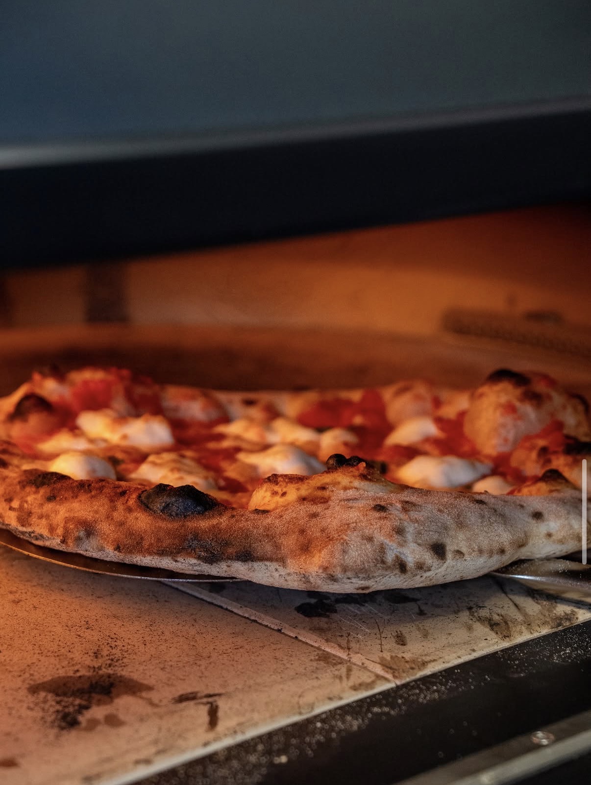Margherita pizza baking in the stone oven
