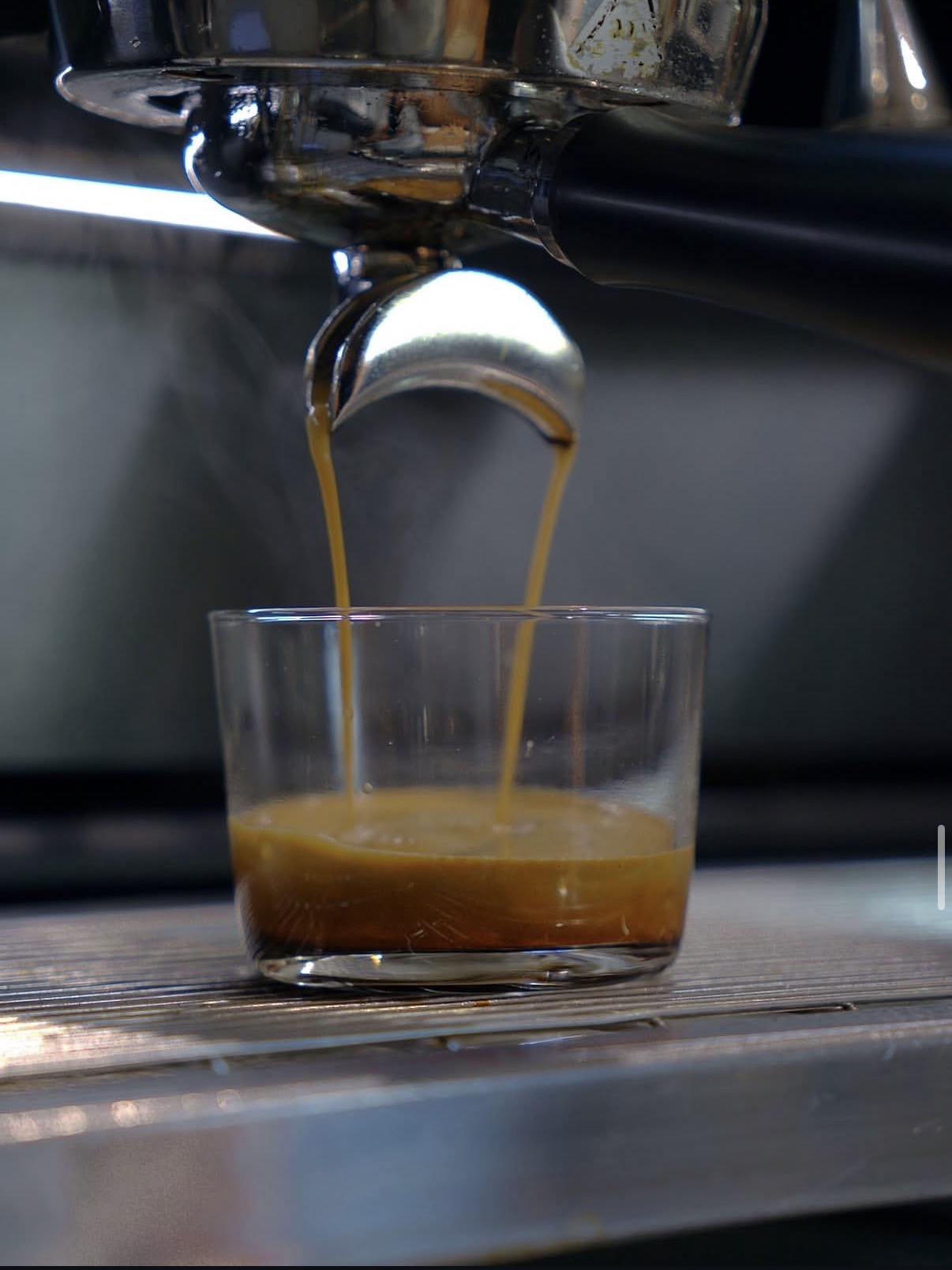 Espresso extracting into a glass