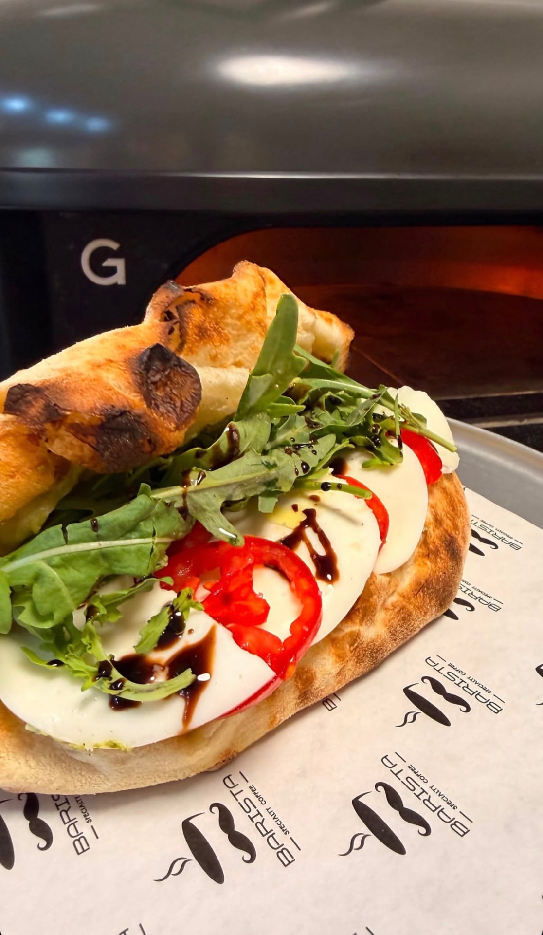 Caprese sandwich with mozzarella, tomato and rocket