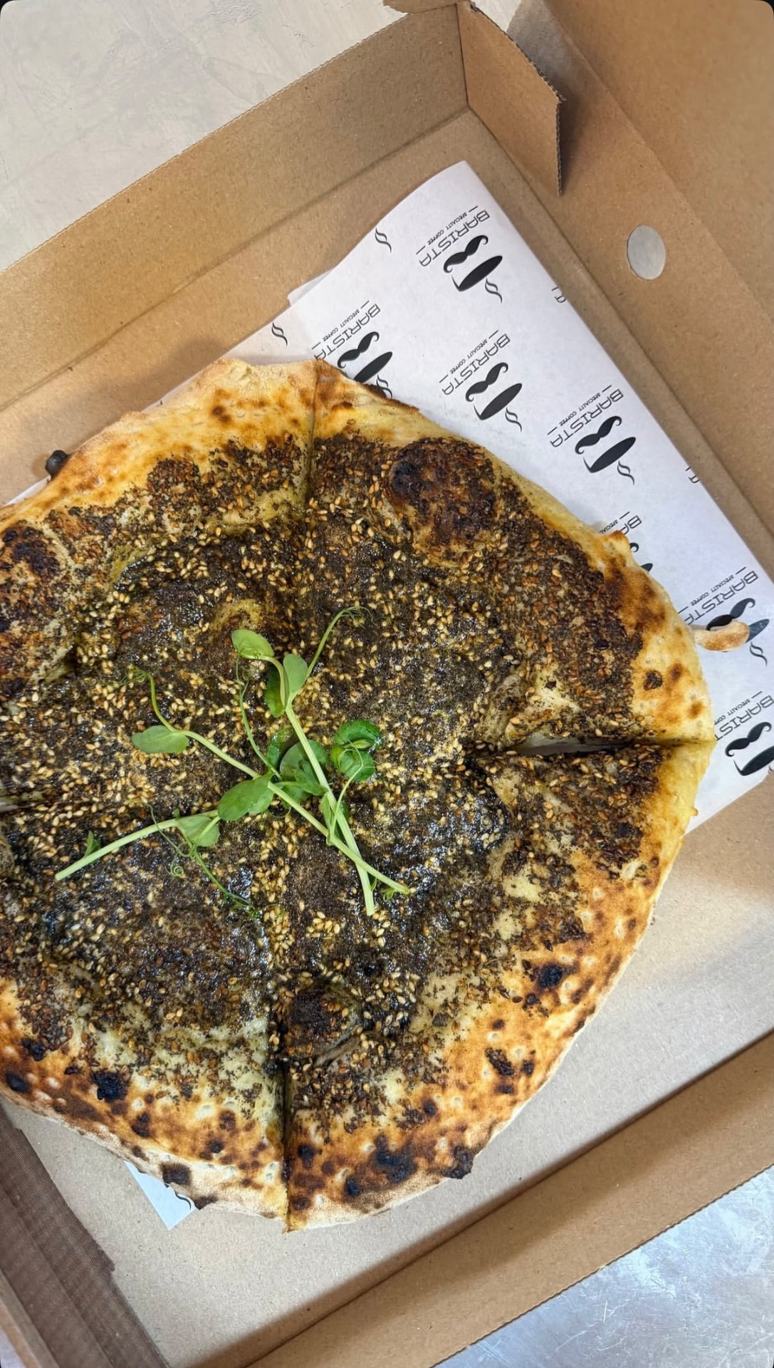 Za'atar manakish fresh out of the taboon oven